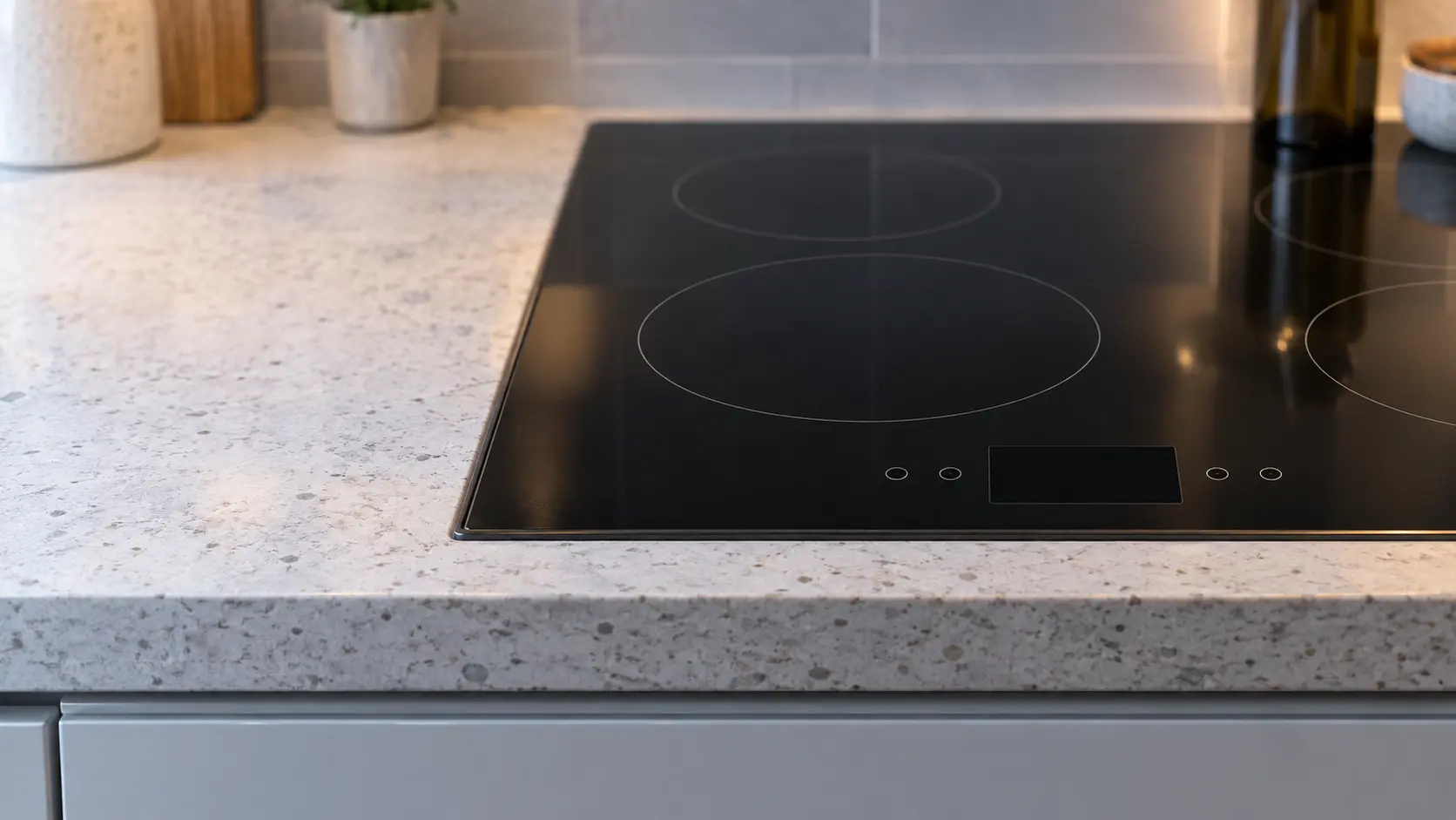 The touch-control strip of a glass cooktop seen close and square on.