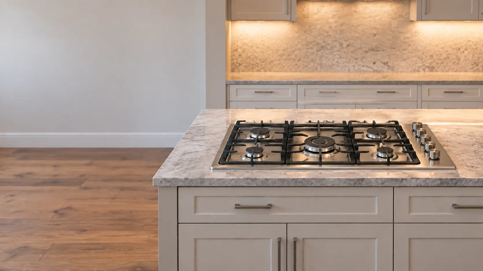 A bright family kitchen with a gas cooktop in the island, seen from across the room.